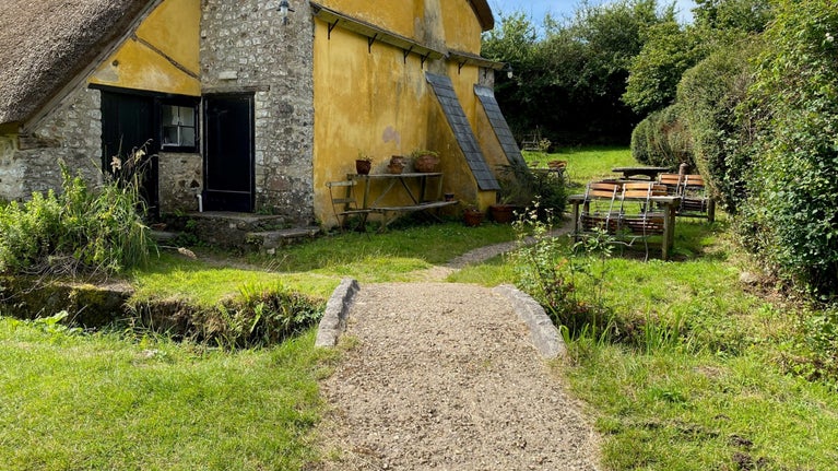 Loose gravel path entering Old Old Bakery tea room gardens